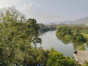 a view of a river with trees on the side at Volk resotel in Ban Nong Chaeng