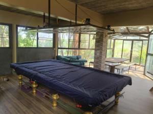 a large bed in a room with a table and chairs at Volk resotel in Ban Nong Chaeng