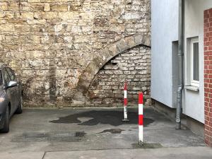 a stone tunnel with a car parked in front of a building at Cityperle Apartment in Erfurt
