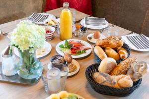 a table with a bunch of breakfast foods on it at Harmls Aparthotel in Flachau