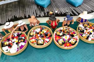 a group of baskets of food in a swimming pool at Villa Manureva in Canggu