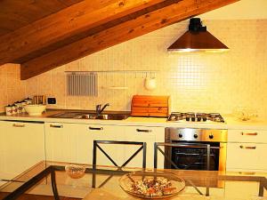 a kitchen with a sink and a stove top oven at Gelsomino home in Furore
