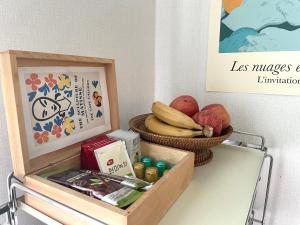 a table with a basket of fruit and a picture at Gold Stream House in Seoul
