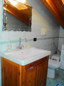 a bathroom with a sink and a toilet at Gelsomino home in Furore +20 photos