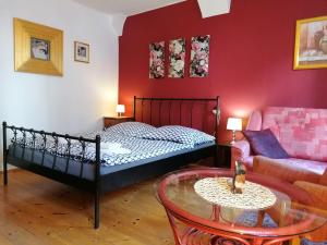 a bedroom with a bed and a couch and a table at Guest House Olšakovský in Český Krumlov +35 photos