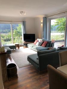 a living room with two couches and a television at Snowdonia Mawddach escape in Dolgellau