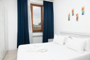 a bedroom with two white beds and a window at Bright 2BR Residence Central Yerevan in Yerevan