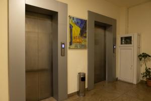 a hallway with two elevators in a building at Bright 2BR Residence Central Yerevan in Yerevan +2 photos