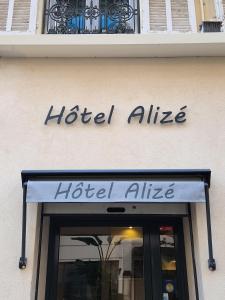 a hotel alliance sign over a store door at Hôtel Alizé in Cannes