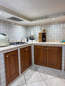 a kitchen with wooden cabinets and a stove in it at HermanHouse in Bacoli