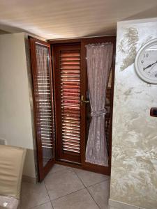 a clock on a wall next to a door at HermanHouse in Bacoli
