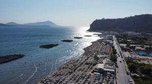 an aerial view of a beach next to the water at HermanHouse in Bacoli