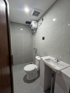 a bathroom with a toilet and a sink at Pangeran Residence 2 in Adi Sutjipto +27 photos