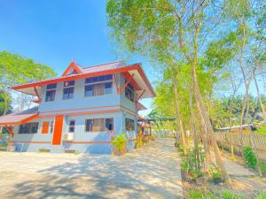 a white house with a red roof at Wandeehomehost in Chiang Mai