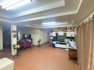 a living room with a couch and a television at Wandeehomehost in Chiang Mai