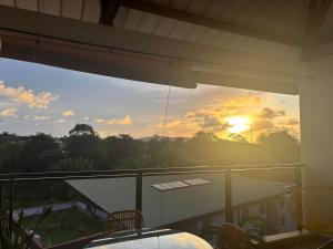 a view of the sunset from the balcony of a house at Apt 1 chb belle déco résidence avec piscine in Rémiré