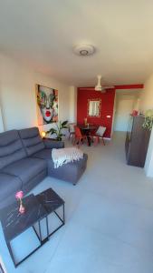 a living room with a blue couch and a table at Casa Nina Novastar in San Pedro del Pinatar