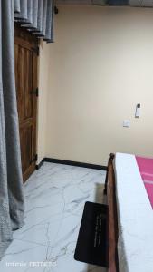 a bedroom with a bed and a book on the floor at Ashi Retreat in Dambulla