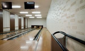a hallway with a row of bowling lanes at Hotel ZRUČ in Zruč nad Sázavou