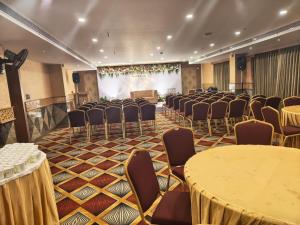a room with rows of chairs and a projection screen at SKY PENTA RESIDENCY in Iritti
