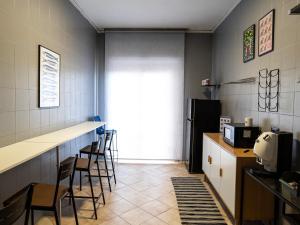 a kitchen with a bar and chairs in a room at Casa e Puteca in Torre del Greco