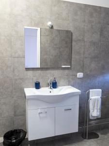 a bathroom with a white sink and a mirror at Casa e Puteca in Torre del Greco +41 photos