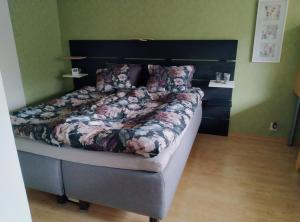 a bedroom with a large bed with a black headboard at Lägenhet Sandåsvägen in Mariehamn