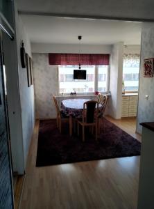 a kitchen and dining room with a table and chairs at Lägenhet Sandåsvägen in Mariehamn