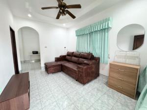 a living room with a couch and a ceiling fan at Vacation Home Tambon Karon in Karon Beach