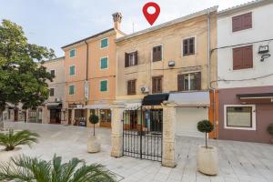 a building with a red heart on top of it at Apartment Seafront Mia in Umag