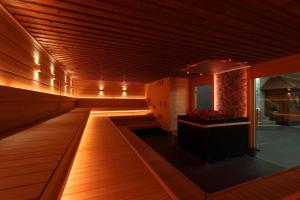 a large room with wooden flooring and a room with a tub at Mauritius Hotel & Therme in Cologne