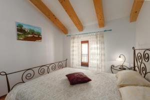 a bedroom with a large bed with a pillow on it at Apartment Seafront Mia in Umag