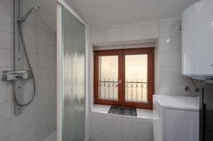a bathroom with a shower and a window at Apartment Seafront Mia in Umag +24 photos