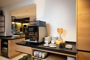 a kitchen with a coffee maker on a counter at Harmls Aparthotel in Flachau +123 photos