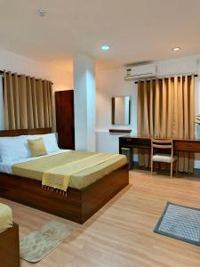 a bedroom with a bed and a desk and a desk at OHANA Homestay in Coron
