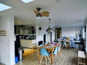 a dining room and living room with a table and chairs at Faodail House in Portree