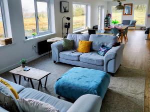 a living room with two couches and a table at Faodail House in Portree
