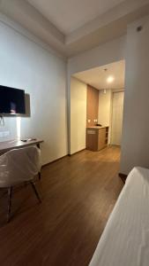 a room with a bed and a desk with a computer at The Pineapple Suite with Gorgeous Views in Greater Noida +7 photos