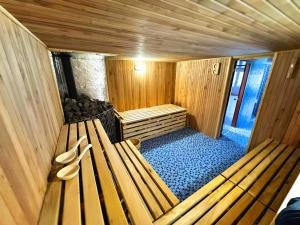 an inside view of a sauna with two shoes on a bench at Zajazd Rest in Przemyśl