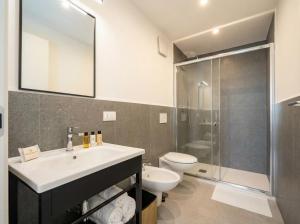 a bathroom with a sink and a toilet and a shower at Dimora dei Colori - Yellow Light in Bari