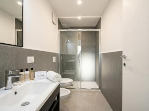 a bathroom with a toilet and a sink and a shower at Dimora dei Colori - Yellow Light in Bari