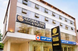 a building with a sign for a global inn and suites at Global Inn & Suites in Mangalore