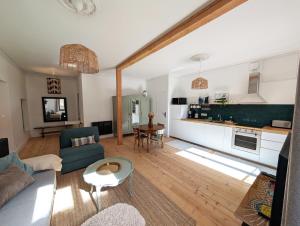 a living room with a couch and a table at Chez flader, deux pièces de 55m2 centre historique in Langeac