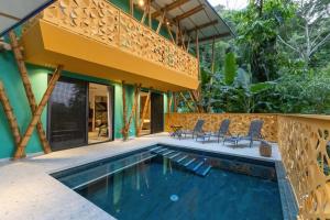 a villa with a swimming pool and a house at Dos Olas Ocean-Inspired Luxury Villa in Quepos