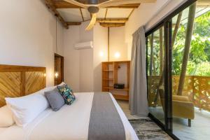 a bedroom with a large bed and glass doors at Dos Olas Ocean-Inspired Luxury Villa in Quepos +68 photos