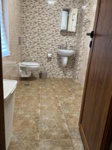 a bathroom with a toilet and a sink at Четири сезона 12 in Stoykite +45 photos