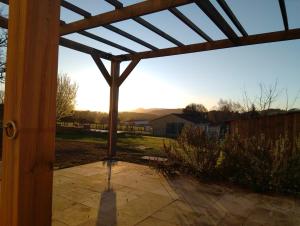 a view from the porch of a pergola at L'atelier in Sugères +3 photos