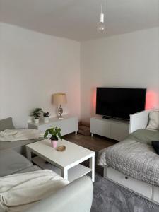 a living room with two couches and a flat screen tv at Apartmán pod Hradem in Most
