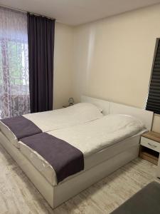 a bedroom with a bed and a window at Четири сезона 12 in Stoykite