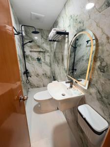 a bathroom with a sink and a mirror at BMF Tropical Homestay in Calampanan +15 photos